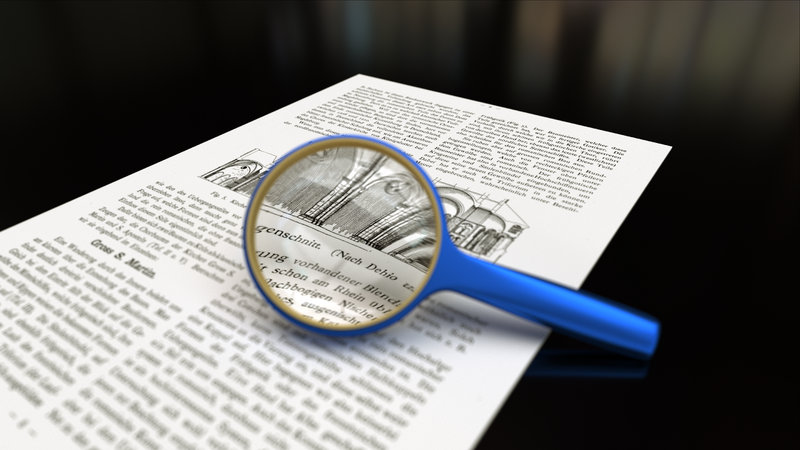 Magnifying glass focusing on a journal article