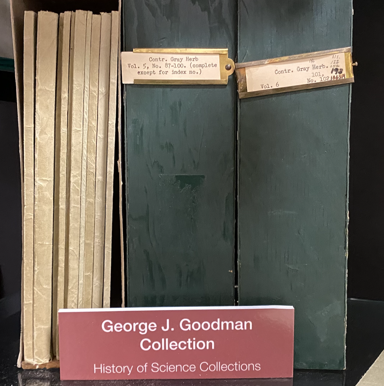 Photo of shelf with print journals and 2 binders and sign for George J. Goodman Collection