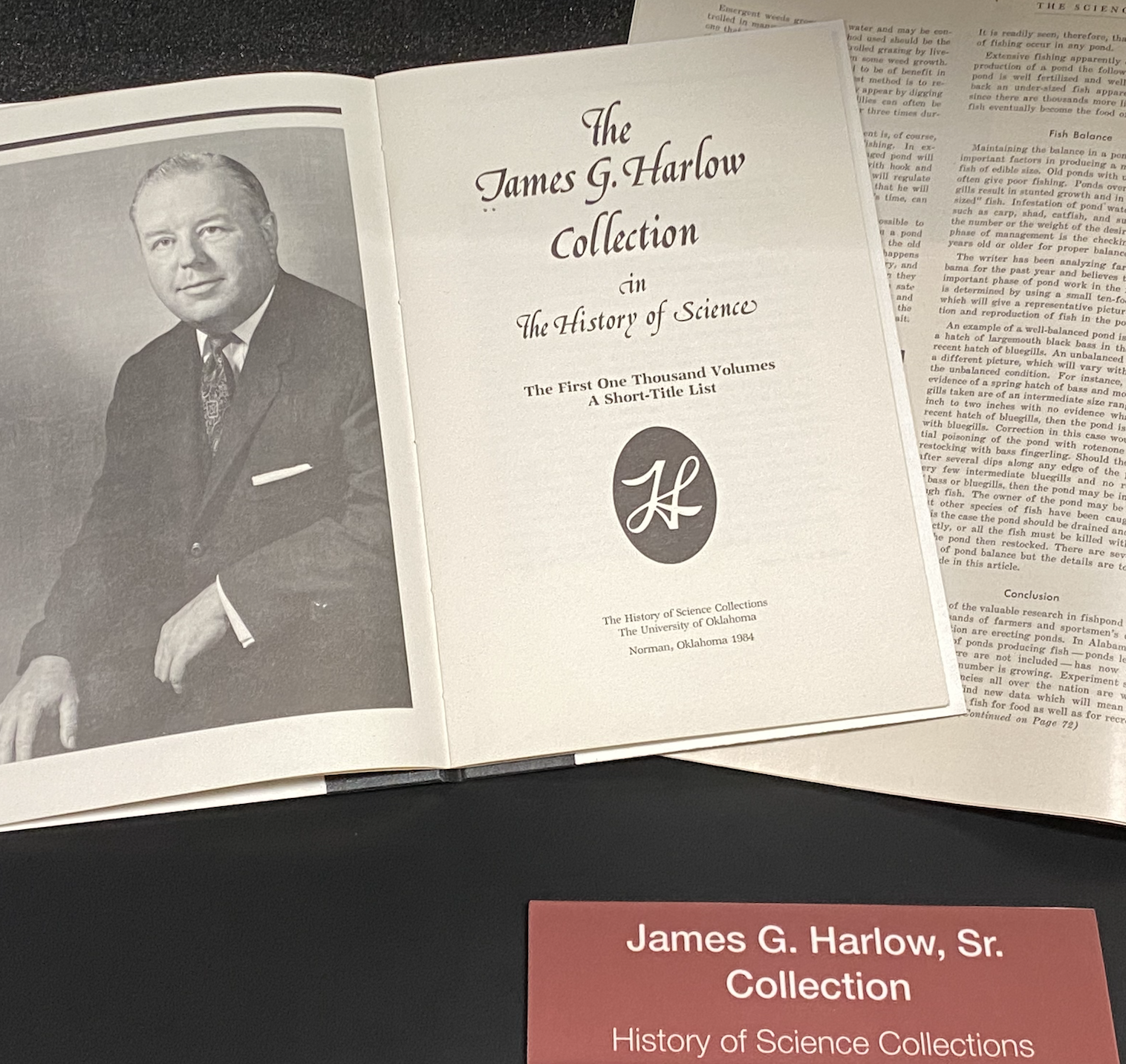 Photo of collection catalog opened to photograph of James G. Harlow, Sr.