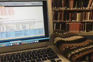 open laptop in the Stacks