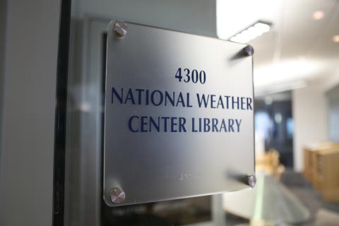 Door sign with the text, "4300 National Weather Center Library."